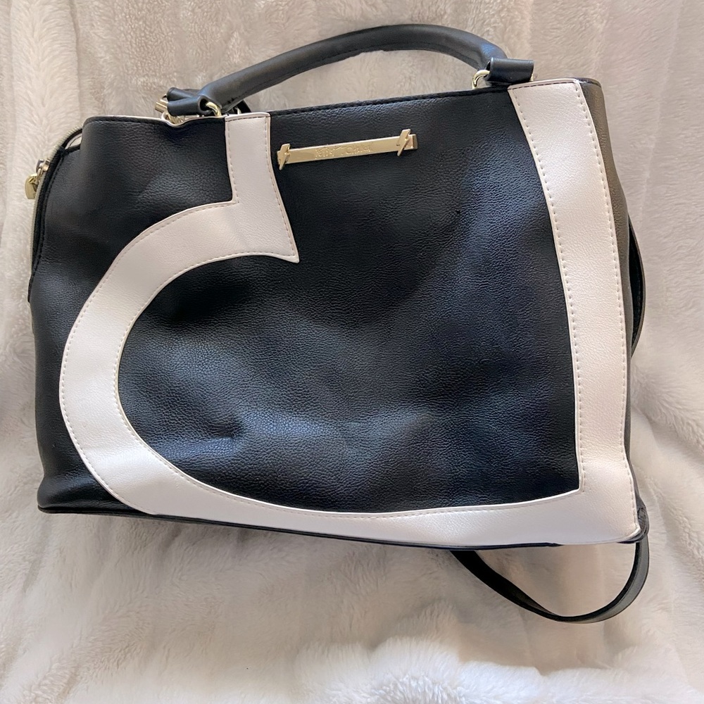 This is a Betsey Johnson slightly used. Good condition at 14”L x 11”H